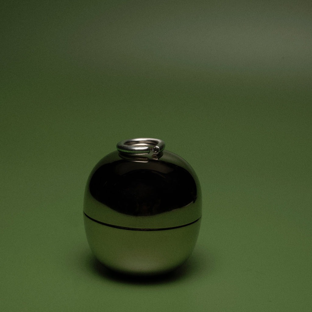 Metallic spherical object on a green background
