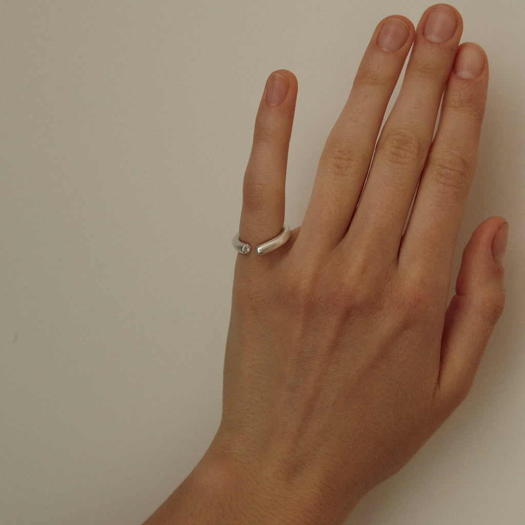 Hand with a ring on a plain background