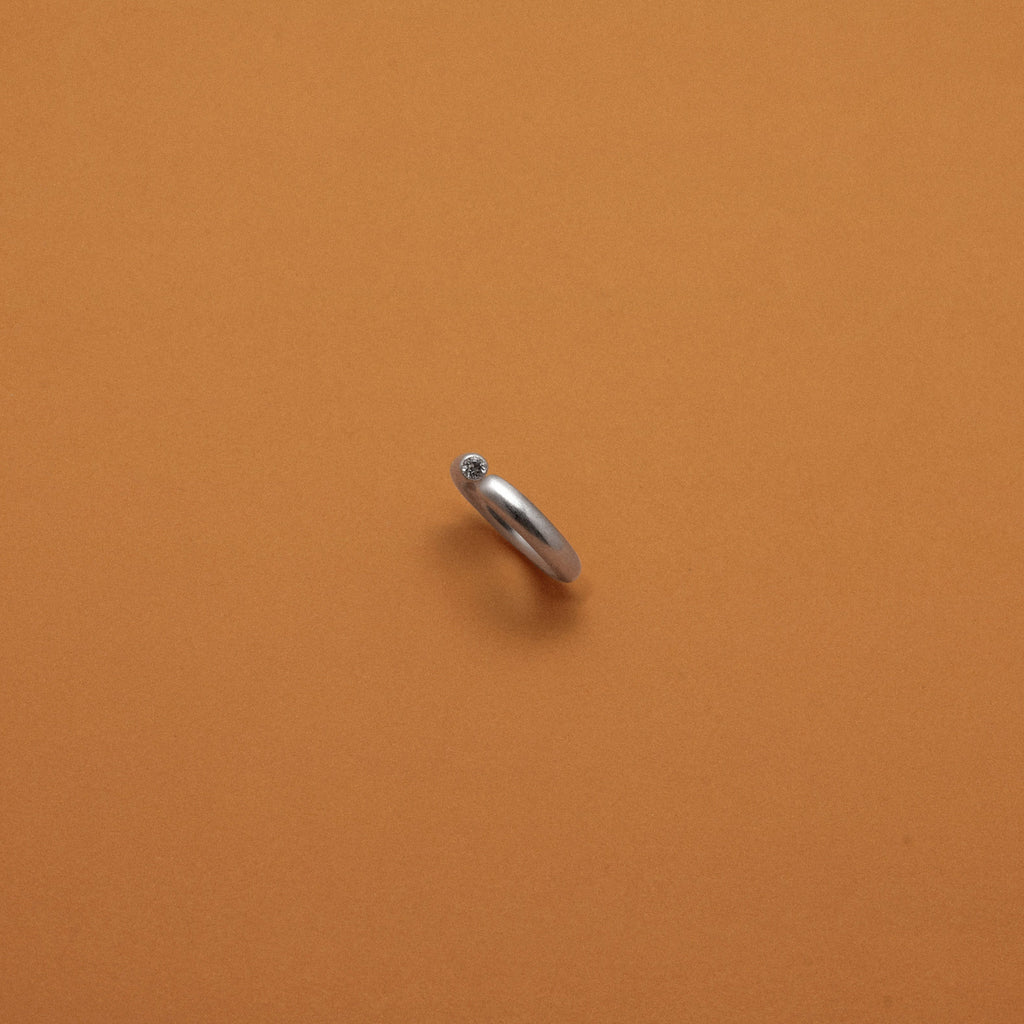 Silver ring on an orange background